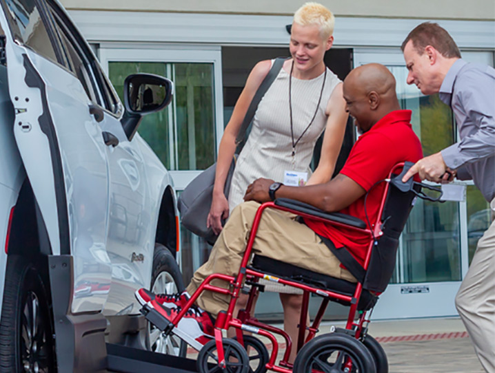 Dodge CharVoyagerger - Lift - Man in wheelchair being loaded into vehicle